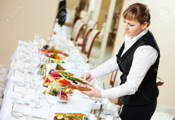 48493974 restaurant catering services female waitress serving banquet table